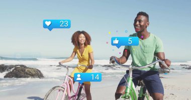 Friends pedaling pink, green bikes on beach with rocky outcrops, with blue notification icons. Coastal, leisure, aquatic, vibrant, outdoor, social, lifestyle