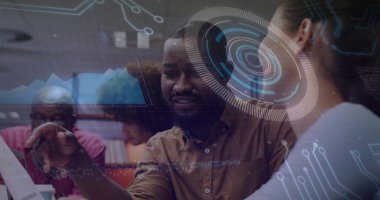 Pointing bearded man leading discussion at open-plan office with laptop, digital overlays. Collaboration, innovation, technology, futurism, teamwork, digital, professional