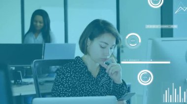 Seated woman scrolling smartphone, activating analytics overlays on desktop and monitoring progress. Collaboration, productivity, digital, modern, teamwork, corporate, communication