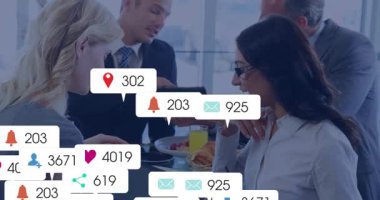 Colleagues tapping devices and monitoring social media bubbles surging then fading at breakfast. Professional, teamwork, communication, digital, urban, vibrant, collaboration