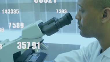 Laboratuvar teknisyenleri mikroskoba yerleştirerek odağı ayarlarken sayısal örtüler analiz için hareket ediyor. Laboratuvar, bilim, araştırma, mikroskop, analiz, veri, kesinlik