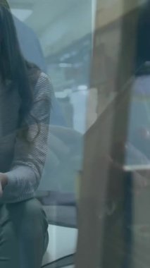 Animation of financial data processing over caucasian businesswoman using smartphone. Global business, finance, computing and data processing concept digitally generated video.