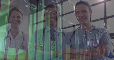 Crossing arms, medical team wearing stethoscopes and scrubs displaying financial charts in corridor. Healthcare, collaboration, analytics, professional, innovation, teamwork, technology