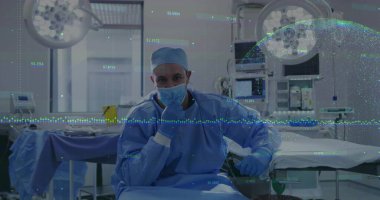 Sitting surgeon in scrubs holding mask on chin in operating room, with floating data overlays. Medical, healthcare, professional, clinical, precision, diagnostic, sterile