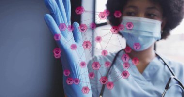 Pulling blue glove, health worker wearing mask and stethoscope in clinic, with pink hexagon network. Medical, healthcare, clinical, science, professionalism, technology, diagnostics