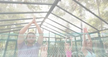 Instructor guiding yoga group entering tree pose for balance under pergola then returning to mat. Wellness, balance, serenity, outdoor, nature, mindfulness, harmony