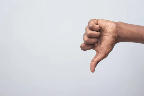 Unlike, dislike, failure gestures concept - Male hand showing dislike thumb down sign isolated on white background. Hand symbol sign language.