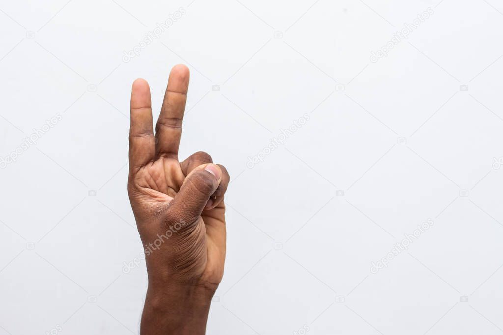 Boy hand showing number two gesture symbol isolated on white background. Gesturing number 2. Number two in sign language. counting down two concept. two fingers up. man hand sign victory gesture.