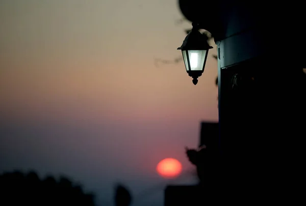 An ancient street lamp on the street at sunset. Greece, Kos Island.