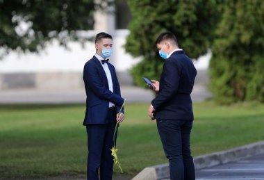 Maske takan öğrenciler ve öğretmenler okula döndüklerinde kendilerini koronavirüsten korurlar. Salgından sonra, öğrenciler yeni okul yılına hazırlanmak için okula geri dönüyorlar. Kedainiai Meslek Eğitim Merkezi. Litvanya