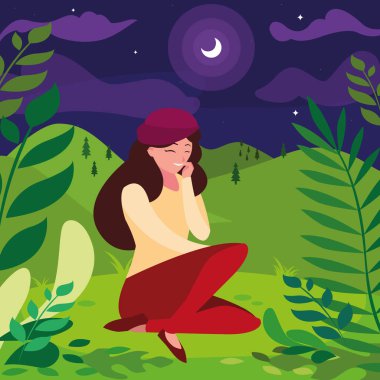 Gece tarlada oturan bereli bir kadın.