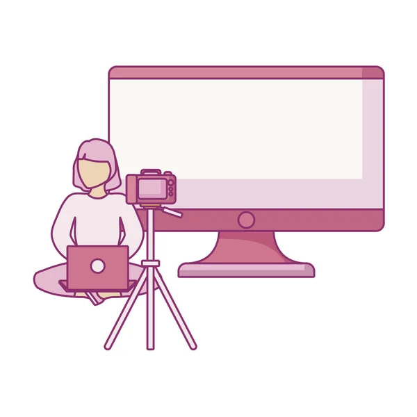 Woman seated using laptop with camera and monitor — 스톡 벡터