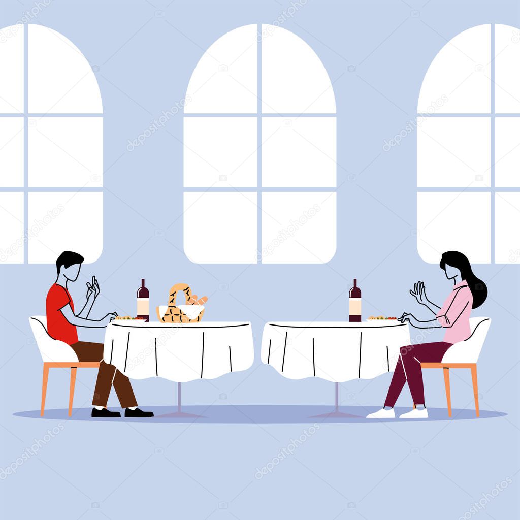 social distance in restaurant, a man and a woman sit a distance apart in separate tables with food