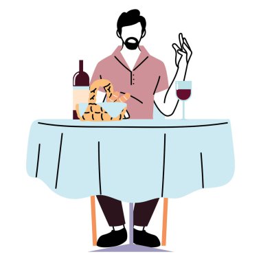 Restoran masasında elinde şarap ve ekmek sepeti tasarımı olan bir adam oturuyor.