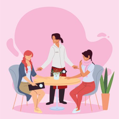 Restorandaki kadınlar ve üniformalı garsonlar siparişleri alıyor.