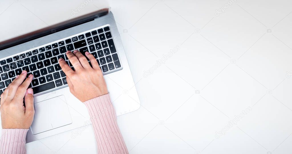 Girl working at home with laptop, freelancer preparing business plan. With blank space for text or design