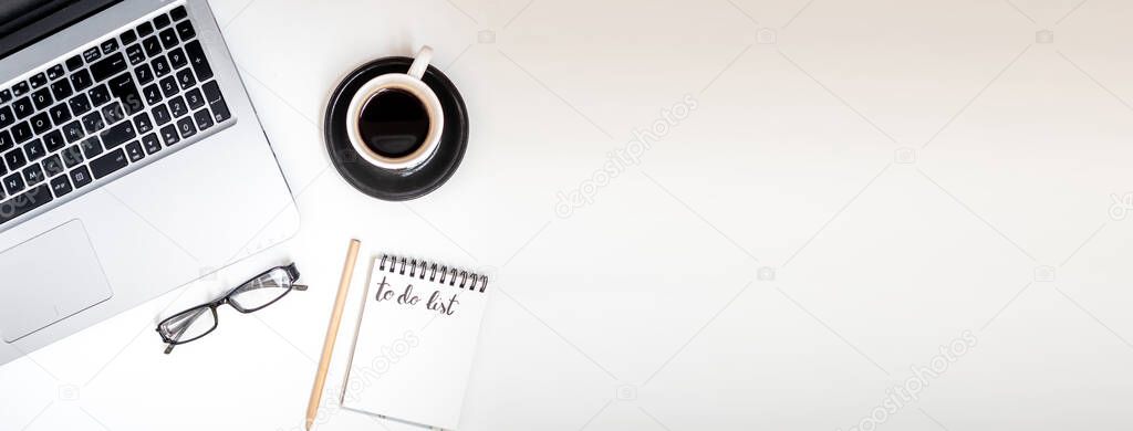 Minimalist office with laptop, coffee and notebook. With blank copy space for design or text