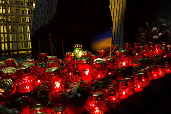 Red candles at night near the holodomor memorial. Honoring the memory of victims of famines in Ukraine