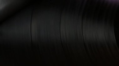 Macro dönen siyah disk. Striptizciler geçmişe taşınıyor.