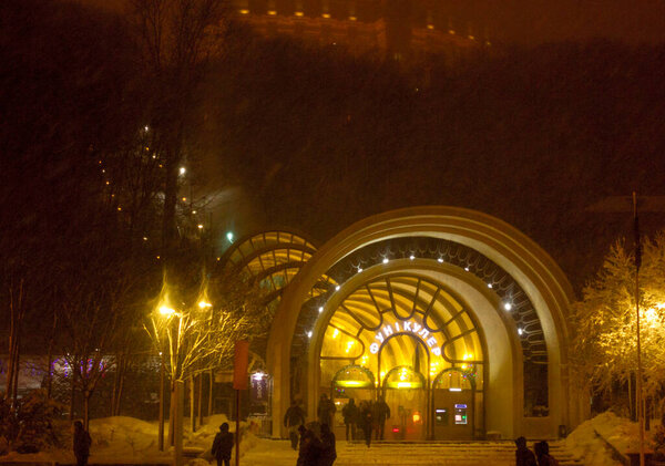 Kiev Funicular at night, winter snow storm. People outside.