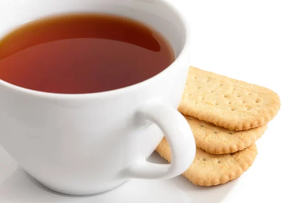 Detail of a white ceramic cup of rooibos tea with finger biscuit — Stock Photo, Image