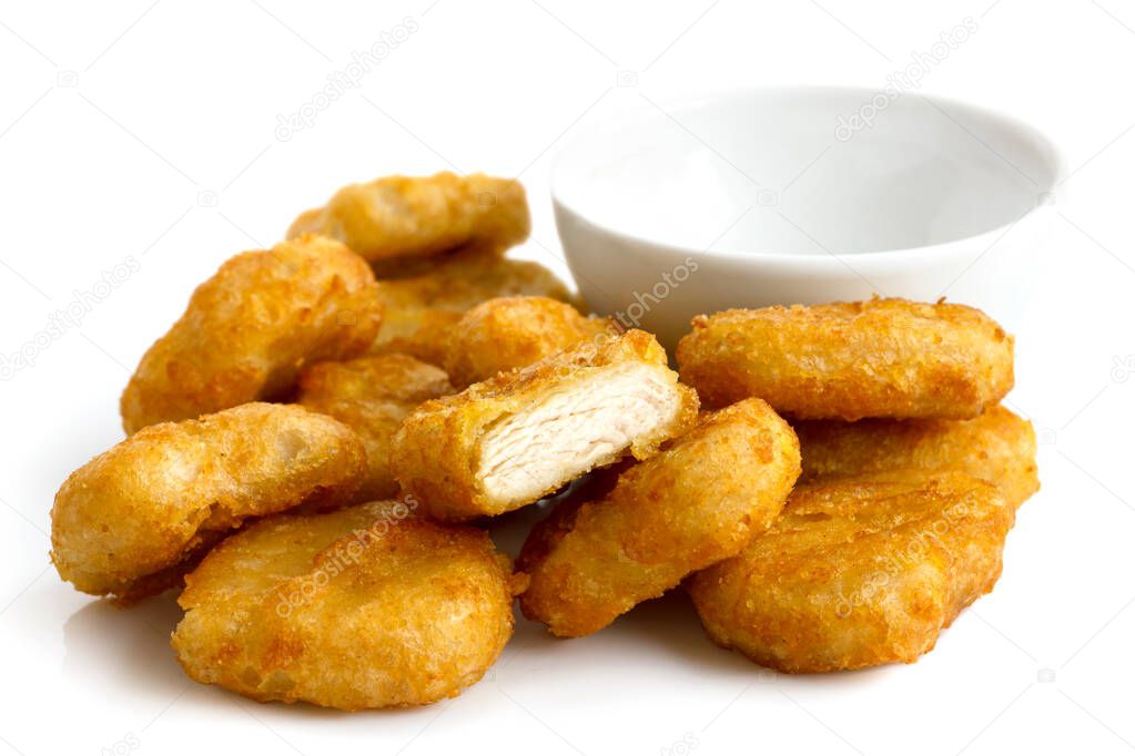 Pile of golden deep-fried battered chicken nuggets with empty bo