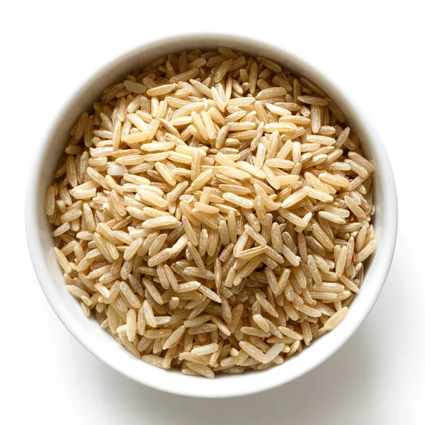 Bowl of long grain brown rice isolated on white from above. — Stock Photo, Image