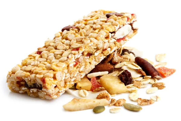 Muesli bar on heap of fruit, seeds and nuts. — Stock Photo, Image