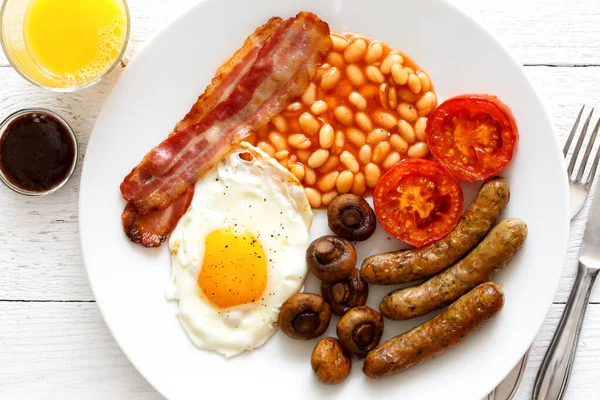 Geleneksel kızarmış İngiliz kahvaltısı ve portakal suyu. — Stok fotoğraf
