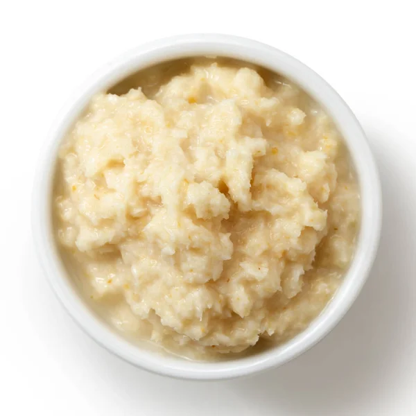 Horseradish sauce in white bowl from above on white. — Stock Photo, Image