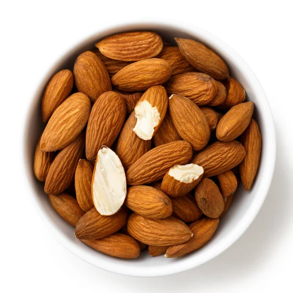 Bowl of whole and broken almonds isolated on white from above. — Stock Photo, Image