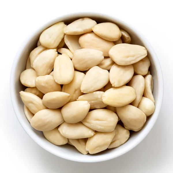 Bowl of peeled whole almonds isolated on white from above. — Stock Photo, Image