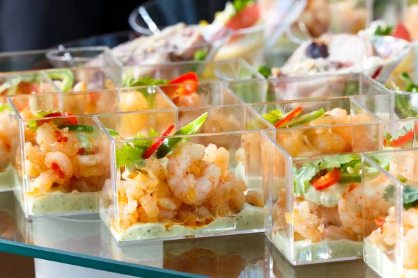 Buffet table detail of prawn canapes in plastic dishes. — Stock Photo, Image