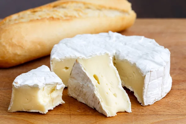 White mould cheese with cut slices half eaten, and baguette, iso — Stock Photo, Image