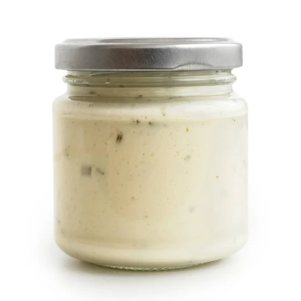 Closed glass jar of white garlic and herb sauce. Isolated in low — Stock Photo, Image
