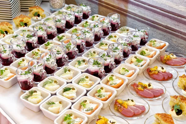Arranged selection of canapes on white table. — Stock Photo, Image