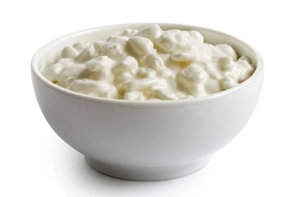 White ceramic bowl of chunky cottage cheese isolated on white. Stock Image