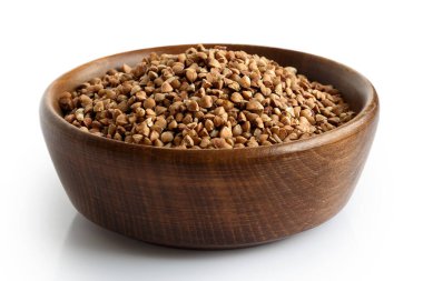 Koyu ahşap kasede pişmemiş karabuğday beyazı izole edilmiş.. 