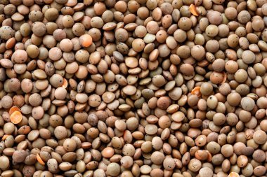 Soyulmamış kırmızı mercimeklerin arka planı.