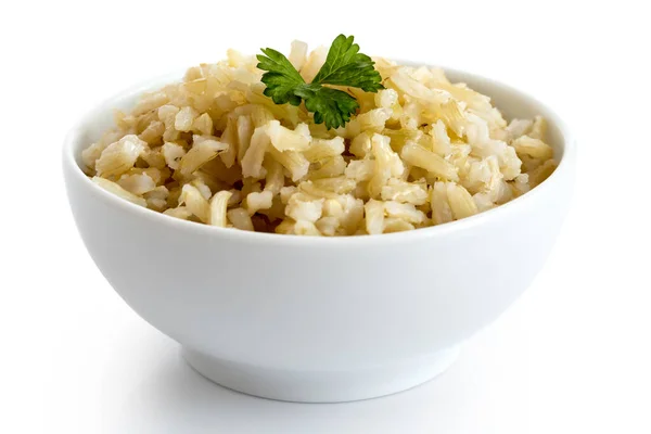 Bowl of cooked long grain brown rice with green parsley isolated — Stock Photo, Image