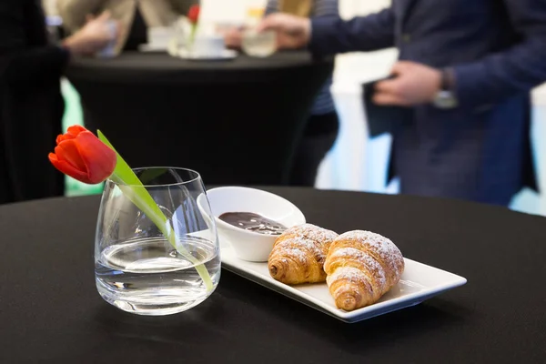 Two plain croissants with chocolate sauce on white plate. With p — Stock Photo, Image