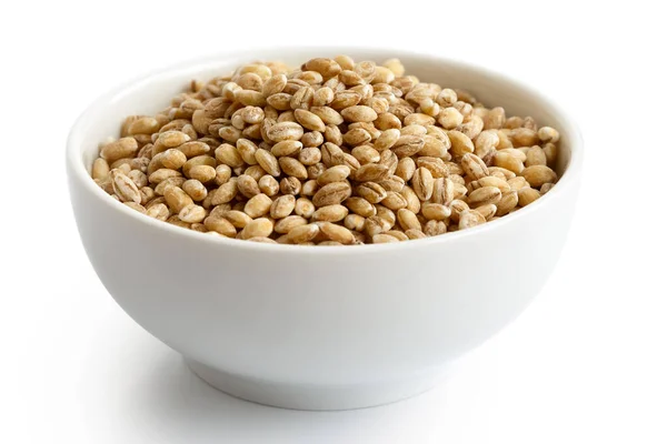 Dry pearl barley in white ceramic bowl isolated on white. — Stock Photo, Image