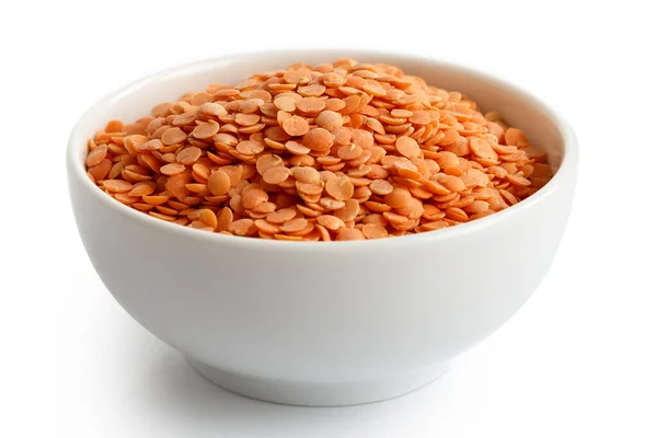 Dry red lentils in white ceramic bowl isolated on white. — Stock Photo, Image