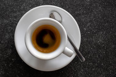 Beyaz seramik bardakta küçük İtalyan espresso kaşıkla izole edilmiş. 