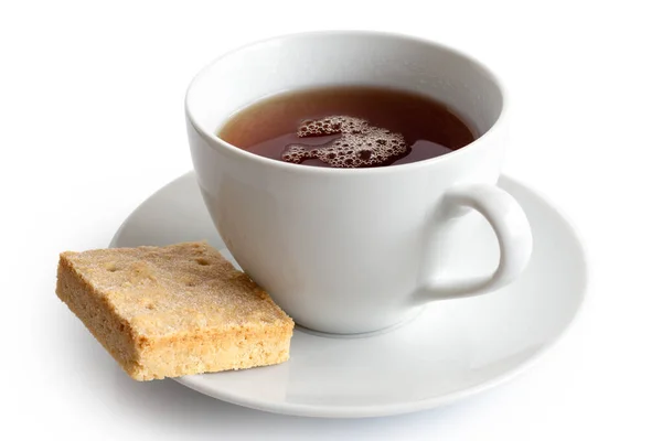 Eine Tasse schwarzen Tee mit quadratischem Shortbread-Keks isoliert auf wh — Stockfoto