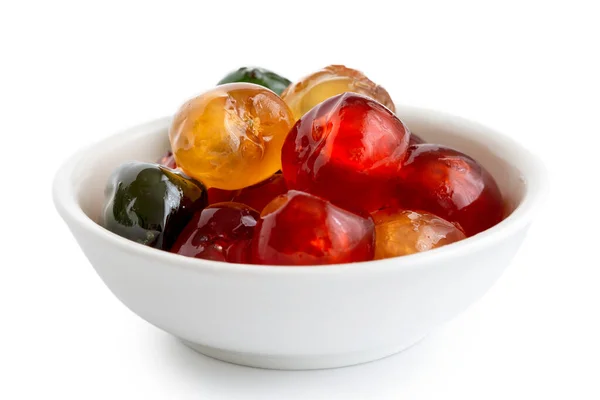 Red, green and yellow glace cherries in white bowl isolated on w — ストック写真