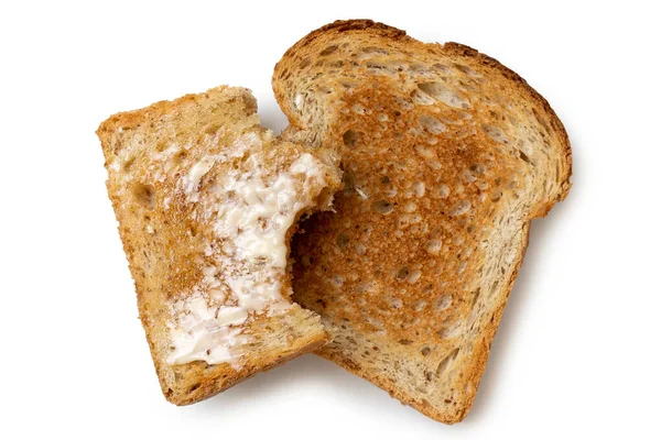 Half eaten buttered slice of whole wheat toast and whole dry sli — Stock Photo, Image