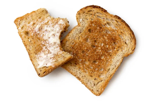 Half eaten buttered slice of whole wheat toast and whole dry sli — Stock Photo, Image