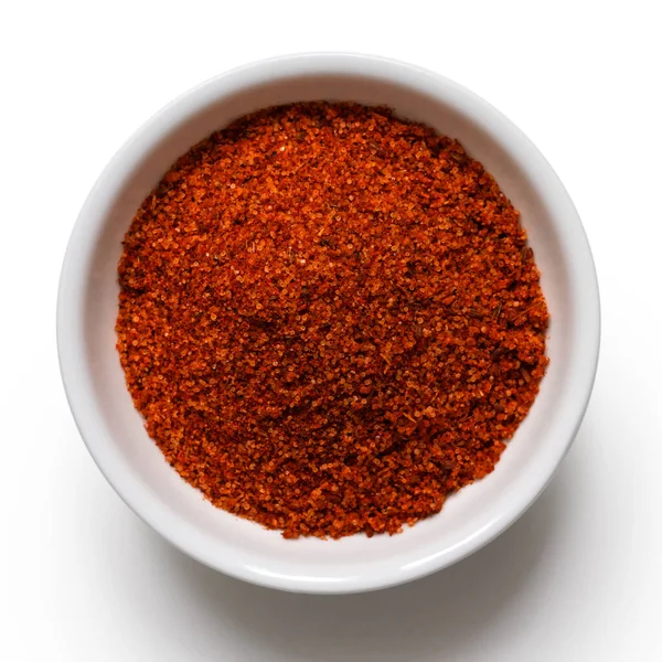 Red bbq spice mix in white ceramic bowl isoslated on white from — Stock Photo, Image