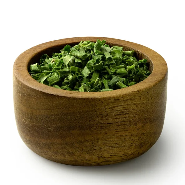 Dried chopped chives in a dark wood bowl isolated on white. — Stock Photo, Image